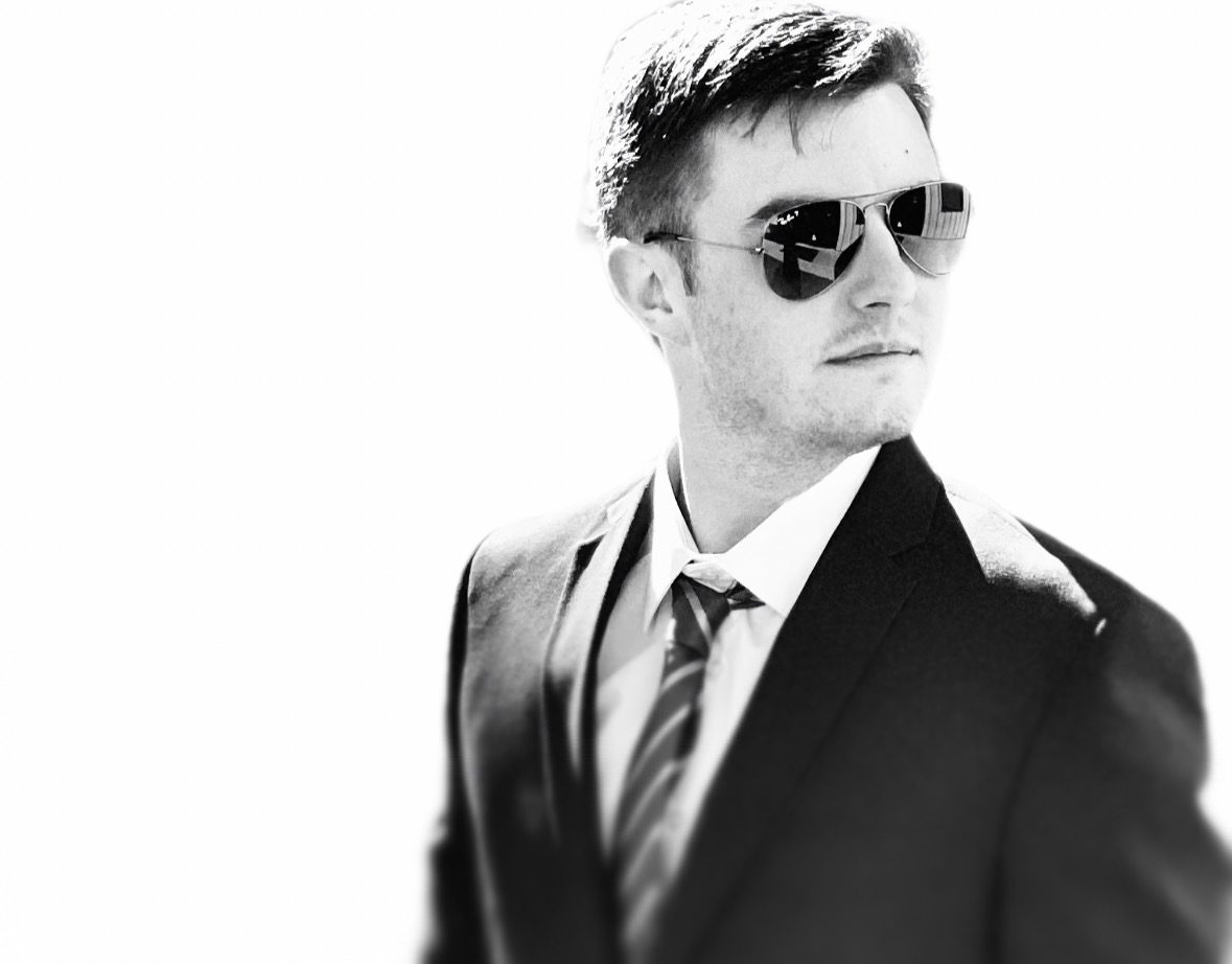 James Permenter, co-owner of Pacific Autohaus, in a suit and sunglasses